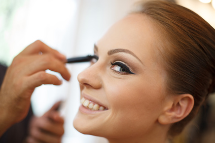 Horizontal photo of bride being made up by make up artist